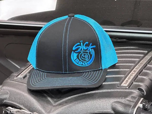 Sick BBQ Blue Snapback resting on an engine